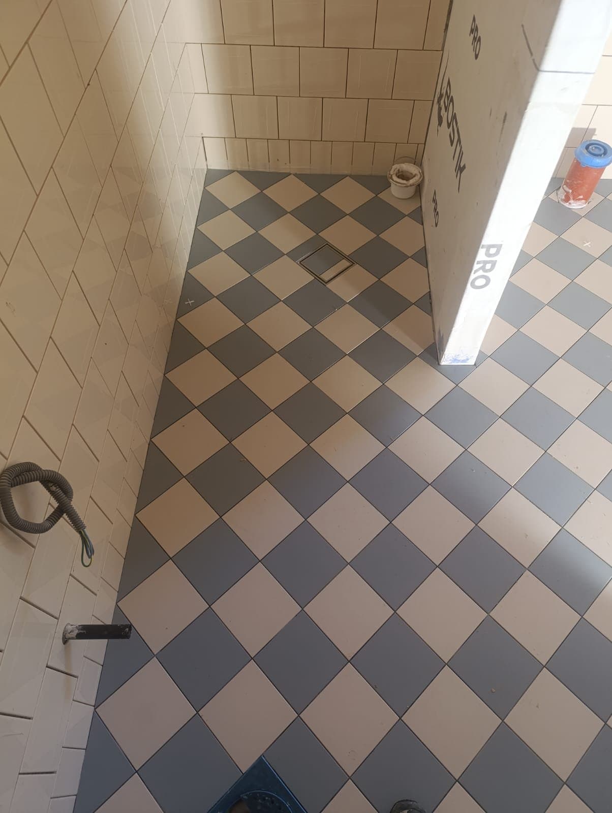 Kaklat golv i schackrutigt mönster i badrum